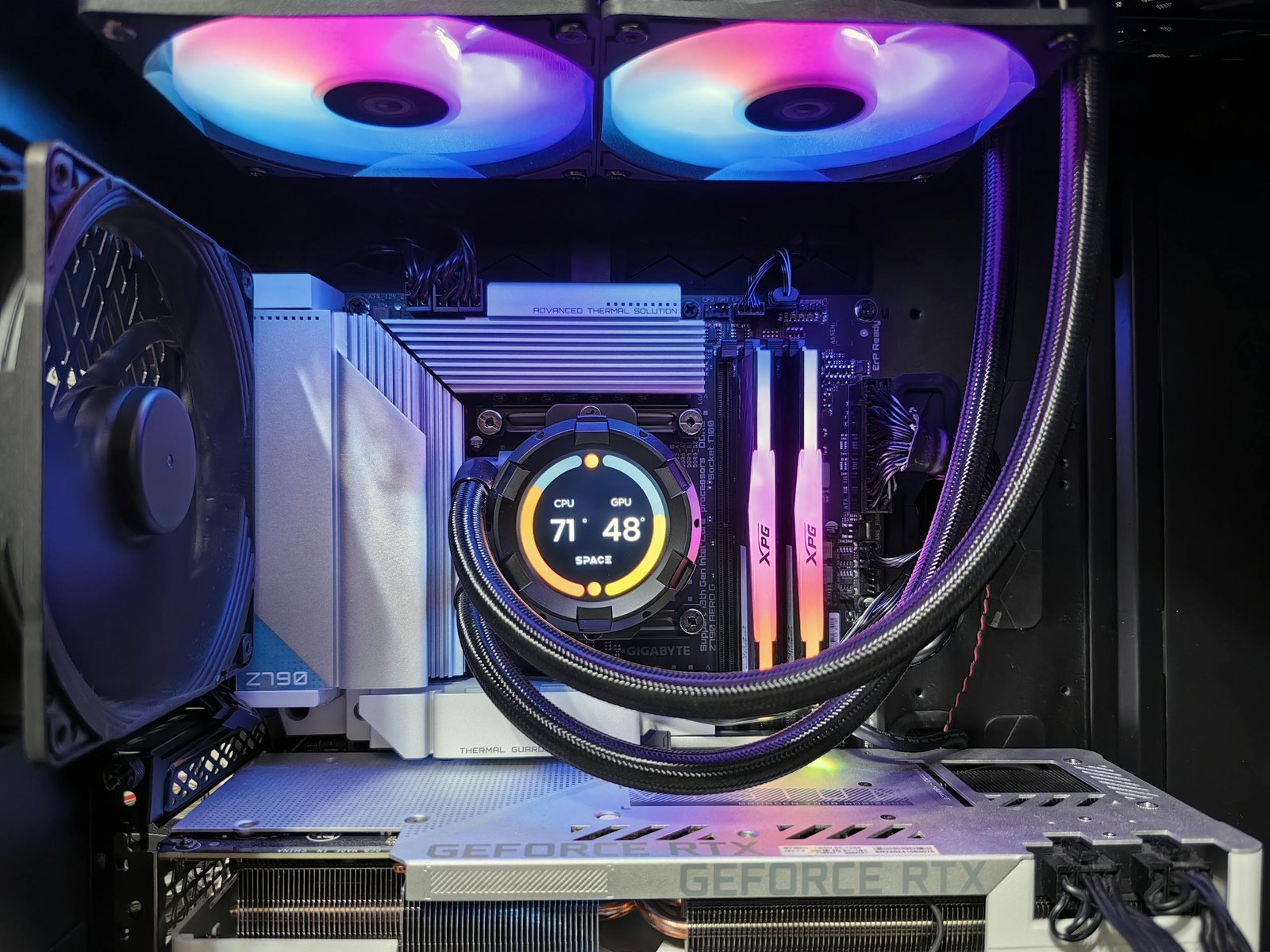 A computer case with a fan and a rainbow colored light